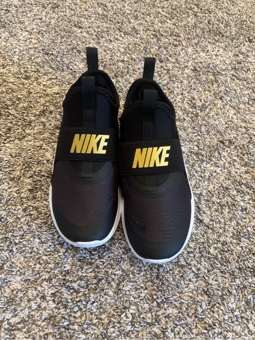 Nike Kids Black Slip-On Sneakers with Gold Logo Strap